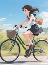 風を切って自転車のペダルを漕ぐ女の子
