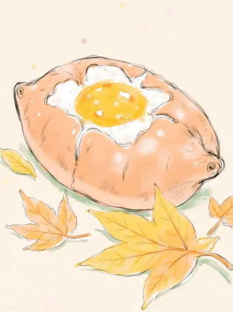 黄金色の中身が見える割れた焼き芋、落ち葉の上、ほくほくの断面