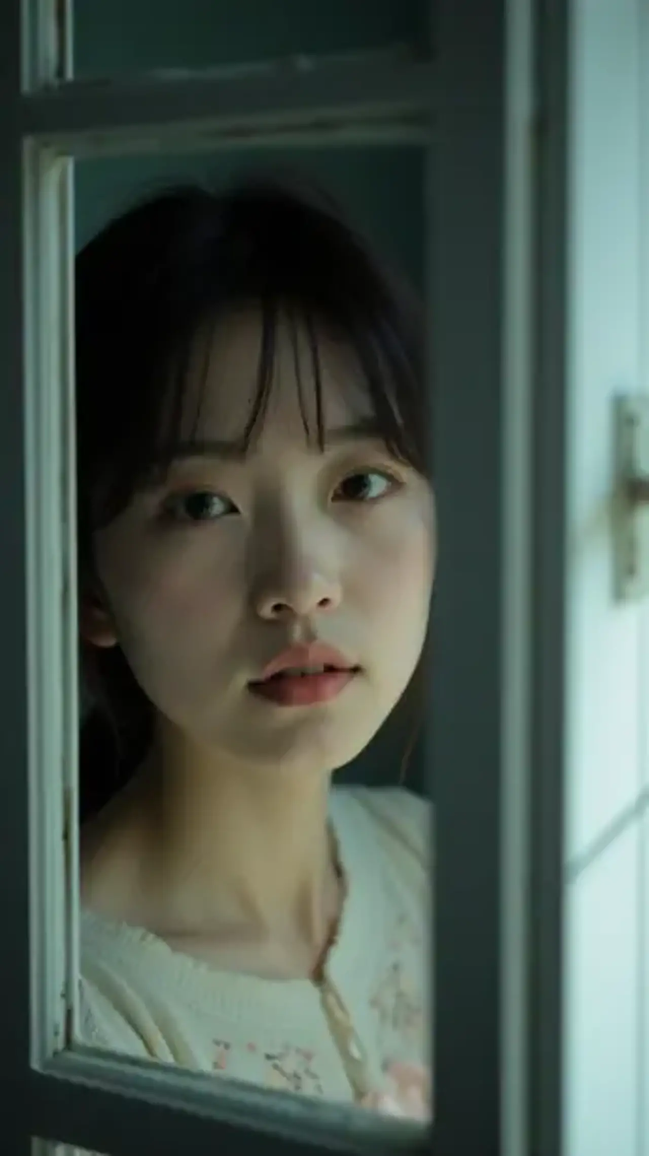 As Rembrandt light filters through window lattice, a maiden’…
